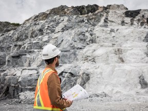 An employee of Sayona Quebec in front of a lithium deposit at the company's North American Lithium Complex in La Corne, central Quebec, 2022.