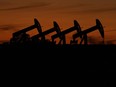 Oil pump jacks operate at dusk near Barnes City, Texas.