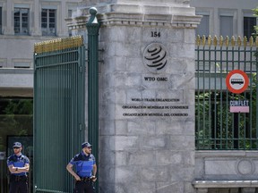 Police officers guard the entrance of the headquarters of the World Trade Organization in Geneva, Switzerland.