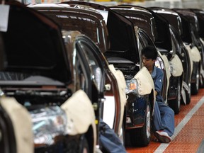Workers building a car on the Geely Motors assembly line in Cixi, in China's Zhejiang province.