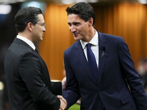 Prime Minister Justin Trudeau and Conservative leader Pierre Poilievre greet each other as they gather in the House of Commons on Parliament Hill in Ottawa.