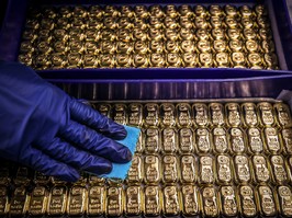 A worker polishes gold bullion bars at the ABC Refinery in Sydney.