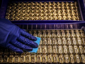 A worker polishes gold bullion bars at the ABC Refinery in Sydney.
