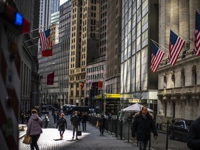 People walk around the New York Stock Exchange.