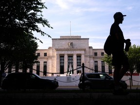 A pedestrian passes the Marriner S. Eccles Federal Reserve building in Washington, D.C.
