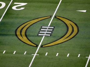 FILE - The College Football Playoff logo is shown on the field at AT&T Stadium before the Rose Bowl NCAA college football game between Notre Dame and Alabama in Arlington, Texas, Jan. 1, 2021. The nine Bowl Subdivision conferences and Notre Dame reached an agreement Friday, March 15, 2024, on a six-year deal to continue the College Football Playoff through the 2031 season, a significant step that establishes a revenue-sharing plan and allows the CFP to finalize a media rights agreement.
