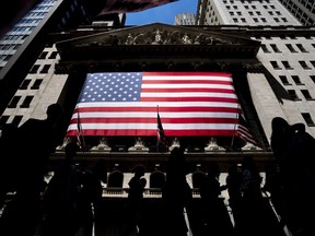 FILE - People walk past the New York Stock Exchange on Wednesday, June 29, 2022 in New York. Wall Street's best week of the year is getting even better Friday, Nov. 3, 2023, following a cooler-than-expected report on the job market.