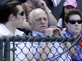 FILE - Peter G. Angelos, center, owner of the Baltimore Orioles, sits in the owners box at Ft.Lauderdale Stadium in Ft. Lauderdale, Fla. with his son, Louis, and wife, Georgia, during his team's spring training baseball game against the Boston Red Sox Sunday, March 18, 2007. Peter Angelos, owner of a Baltimore Orioles team that endured long losing stretches and shrewd proprietor of a law firm that won high-profile cases against industry titans, died Saturday, March 23, 2024. He was 94.