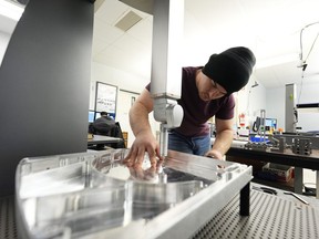 FILE - A worker at Reata Engineering and Machine Works prepares a Hexagon machine used to confirm that parts meet customer standards on Feb.15, 2024, in Englewood, Colo. On Thursday, March 14, 2024, the Labor Department releases producer prices data for February.