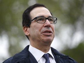FILE - Former Treasury Secretary Steve Mnuchin speaks with reporters outside the White House, March 29, 2020, in Washington. Mnuchin says he's going to put together an investor group to buy TikTok, a day after the House of Representatives passed a bill that would ban the popular video app in the U.S. if its China-based owner doesn't sell its stake.