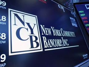 FILE - The logo for New York Community Bancorp is displayed above a trading post on the floor of the New York Stock Exchange, Jan. 31, 2024. New York Community Bancorp's stock plunged even more Wednesday, March 6, 2024 sending it below $2 and down more than 80% for the year so far.