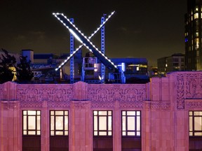 FILE - Workers install lighting on an "X" sign atop the company headquarters, formerly known as Twitter, in downtown San Francisco, July 28, 2023. A federal judge has dismissed a lawsuit by Elon Musk's X Corp. against the non-profit Center for Countering Digital Hate, which has documented the increase in hate speech on the site since it was purchased by the Tesla owner. On Monday, March 25, 2024 U.S. District Court Judge Charles Breyer dismissed the suit, writing in his order that it was "unabashedly and vociferously about one thing" -- punishing the nonprofit for its speech.