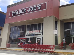 FILE - People stand in line waiting to enter Trader Joe's to buy groceries in Pembroke Pines, Fla., on March 24, 2020. More than 61,000 pounds of steamed chicken soup dumplings sold at Trader Joe's are being recalled for possibly containing hard plastic, U.S. regulators announced Saturday, March 2, 2024.