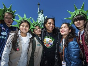 This photo provided by Girl Scouts of Greater New York shows Girl Scouts Troop 6000 paying a visit to the Statue of Liberty in New York in 2023. Troop 6000 has served kids who live in New York's shelter system since 2017, quietly welcoming hundreds of the city's youngest new residents with the support of donations.