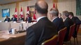 Prime Minister Justin Trudeau, right, takes part in a Long Term Investment Summit infrastructure roundtable as Minister of Finance Bill Morneau, left, looks on with international investors at Toronto's Ritz-Carlton Hotel, Nov. 14, 2016.