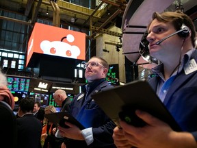 Traders work during the Reddit Inc. initial public offering on the floor of the New York Stock Exchange on Thursday.