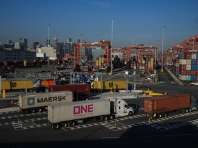 The spike in freight crime comes in lockstep with a ramp-up of more sophisticated, digitally-savvy tactics that revolve around identity theft and drain the economy of millions of dollars, as the higher cost of living drives demand for pilfered products. Trucks carrying cargo containers arrive at the Port of Vancouver Centerm container terminal, in Vancouver, on Friday, October 14, 2022.