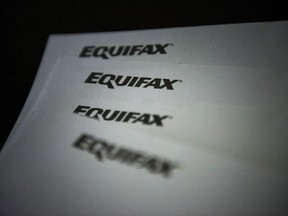 Equifax logos are shown on paper in Toronto on Oct.17, 2019. Equifax Canada says Ontario and British Columbia saw mortgage delinquency rates soar in the fourth quarter of 2023, surpassing pre-pandemic levels.THE CANADIAN PRESS/Christopher Katsarov