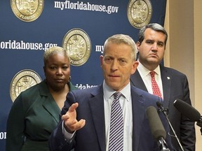 Florida's Republican House Speaker Paul Renner discusses Gov. Ron DeSantis' veto of a bill that would have banned kids under 16 from social media regardless of parental consent, in Tallahassee, Fla., Friday, March 1, 2024. A new proposal lowers that age to 14. He was joined by Democratic Rep. Michele Rayner, left, and Republican Rep. Tyler Sirois, right.