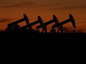 Oil pump jacks operate at dusk near Barnes City, Texas, Wednesday, Nov. 1, 2023. U.S. regulators are scheduled to decide Wednesday, March 6, 2024, on a rule that would require companies to disclose the extent of their greenhouse gas emissions and other climate risks.