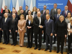 Polish Prime Minister Donald Tusk, third right, and Ukrainian Prime Minister Denys Shmyhal shake hands during a group photo, as they meet for bilateral talks in Warsaw, Poland, Thursday, March 28, 2024.