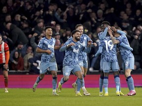 Aston Villa's Lucas Digne, right, is congratulated by his team mates after scoring his sides third goal during the English Premier League soccer match between Luton Town and Aston Villa at Kenilworth Road Stadium in Luton, England, Saturday, March 2, 2024.
