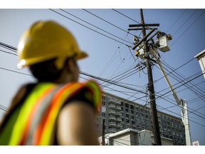 Puerto Rico Electric Power Authority employees fix power lines in Santurce, Puerto Rico.