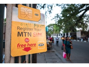 A SIM registration sign hangs next to an MTN Group Ltd. roadside kiosk in Lagos, Nigeria, on Monday, Nov. 13, 2017. MTN is focused on laying the groundwork for an initial public offering of its Nigerian business and should complete the process in the next six months, Chief Executive Officer Rob Shuter said.
