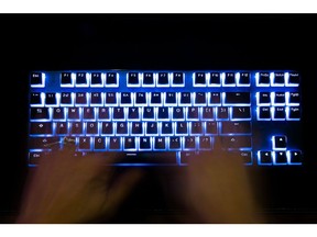 A person types at a backlit keyboard arranged in Danbury, U.K., on Thursday, Jan. 7, 2021. In the spring, hackers managed to insert malicious code into a software product from an IT provider called SolarWinds Corp., whose client list includes 300,000 institutions.