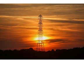 The sun sets behind an electricity pylon near Bradwell-on-sea, U.K., on Tuesday, Sept. 21, 2021. Photographer: Chris Ratcliffe/Bloomberg