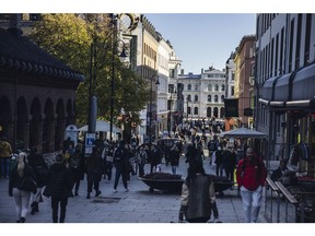 Shoppers walk along Karl Johans gate, the main shopping street, in Oslo, Norway, on Thursday, Oct. 21, 2021. Norway's $1.4 trillion sovereign wealth fund, the world's biggest, returned 0.1% in the third quarter, after its bonds and real estate holdings offset a slight decline in stock portfolio.