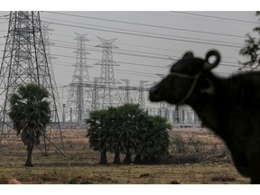 Power lines and transmission towers at the site for Pharma City in Hyderabad, India, on Tuesday, March 22, 2022. On the edge of Hyderabad in southern India, a vast patch of arid shrub-land the size of about 14,000 football fields is becoming a testing ground for a model that could help wean the world off its dependence on Chinese drug ingredients. Photographer: Dhiraj Singh/Bloomberg