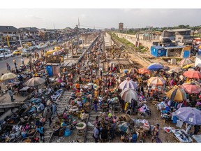 Stalls spill onto railway tracks at the Oshodi market in Lagos, Nigeria, on Wednesday, Nov. 23, 2022. Nigeria's economy grew 2.25% year-on-year in the third quarter amid a drop in the West African country's oil production.