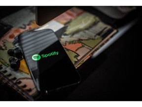 The Spotify logo on a smartphone arranged in Hastings-on-Hudson, New York, US, on Wednesday, Jan. 25, 2023. Spotify Technology SA is planning to cut about 6% of its employees, or around 600 employees, joining a slew of technology companies from Amazon.com Inc. to Meta Platforms Inc. in announcing job cuts to lower costs. Photographer: Tiffany Hagler-Geard/Bloomberg
