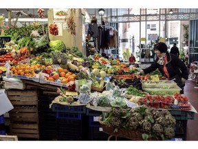 Customers shop for fruit and vegetable produce at an indoor market in downtown Rome, Italy, on Tuesday March 28, 2023. Italy is due to report their latest inflation figures on Friday. Photographer: Alessia Pierdomenico/Bloomberg