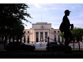 A pedestrian passes the Marriner S. Eccles Federal Reserve building in Washington, DC, US, on Saturday, June 3, 2023. Signs of labor-market slackening in May despite a pickup in hiring are likely to keep the Federal Reserve on hold this month while policymakers mull a hike later in the summer.