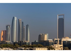 The Etihad Towers, left, and the headquarters of the Abu Dhabi National Oil Co. (ADNOC), right, in Abu Dhabi, United Arab Emirates, on Tuesday, Oct. 3, 2023. The ADIPEC annual strategic energy conference runs from Oct 2-5. Photographer: Christopher Pike/Bloomberg