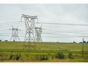 Electricity pylons at the Eskom Holdings SOC Ltd. Arnot coal-fired power station in Mpumalanga, South Africa, on Tuesday, Dec. 26, 2023. Coal-fired power plants operated by South Africa's state utility are emitting pollutants that primarily cause respiratory diseases such as asthma at almost 42 times the intensity of those in China. Photographer: Waldo Swiegers/Bloomberg