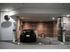 An Enechange Ltd. electric vehicle charging station in the basement of a commercial property in Tokyo, Japan, on Tuesday, Feb. 13, 2024. Enechange, Japan's biggest provider of electric car chargers, is urging the government to mandate priority parking spaces for EVs -- a request that at least in part stems from the nation's low level of EV ownership.