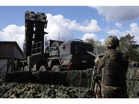 A reservist member of the German armed forces stands next to a launcher of a Patriot missile system in Munster, Germany on Aptil 18.