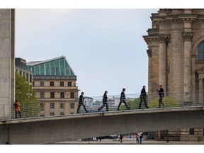 Robert Habeck, Germany's economy minister, center, crosses a bridge between government buildings following a news conference in Berlin, Germany, on Wednesday, April 24, 2024. German business sentiment improved to its highest level in a year -- reinforcing recent signs that Europe's largest economy is exiting two years of struggles.