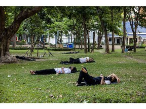 People rest under trees to shade from the sun at a park during high temperatures in Bangkok, Thailand, on Sunday, April 28, 2024. Southeast Asia's second-largest economy has been bracing for hotter-than-normal days due to the El Nino weather pattern that's forecast to last until June. Photographer: Andre Malerba/Bloomberg