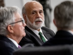 FILE - Former Federal Reserve Chairman Ben Bernanke, center, accompanied by Federal Reserve Chairman Jerome Powell, left, speaks during the Thomas Laubach Research Conference at the William McChesney Martin Jr. Federal Reserve Board Building in Washington, on May 19, 2023. A review of the Bank of England's economic forecasting that was published Friday April 12, 2024 and undertaken by Ben Bernanke, the former chair of the U.S. Federal Reserve, has found "significant shortcomings" that should be addressed to better inform future interest rate decisions.