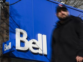 Man walks in front of Bell sign
