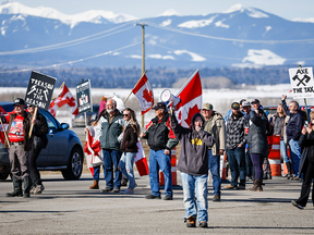 Anti-carbon tax protesters wave signs