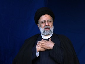 FILE- Iranian President Ebrahim Raisi places his hands on his heart as a gesture of respect to the crowd during the funeral ceremony of the victims of Wednesday's bomb explosion in the city of Kerman about 510 miles (820 kms) southeast of the capital Tehran, Iran, Jan. 5, 2024. Raisi arrived in Sri Lanka on Wednesday to inaugurate a hydro-power irrigation scheme that had long been delayed due to international sanctions.