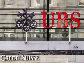 FILE - Logos of the Swiss banks Credit Suisse and UBS are seen on two buildings in Zurich, Switzerland, Saturday, March 18, 2023. The Swiss government has announced steps to bolster its "too big to fail" rules aimed to avoid potentially disastrous fallout from banking sector turmoil. The comes in the wake of woes at troubled bank Credit Suisse before it was taken over by rival UBS.