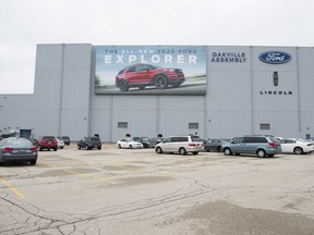 A parking lot with employees' vehicles is shown at the Ford assembly plant in Oakville, Ont.