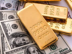 Gold bars and U.S. dollars