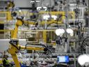 Articulated robots move inside the Hanwha Qcells Solar plant, Oct. 16, 2023, in Dalton, Ga. On Thursday, April 25, 2024, the U.S. government issued the first of three estimates of economic growth in the first quarter.